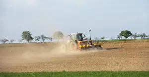 Farming In Southern Germany Drucke: Tractor with seed drill in the field in spring