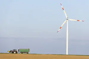 Wind Turbine Germany Drucke: Tractor with trailer in a field
