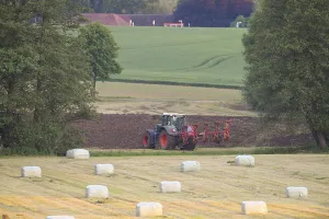 Green Fields Germany Drucke: A tractor working in the field