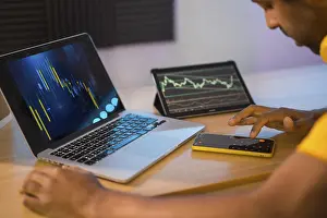 One Person Working On Pc Drucke: Trader using computer and electronic devices to work in remote from home