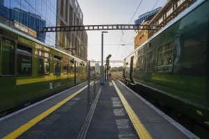 Modern Irish Architecture Drucke: Two trains in the train station at sunset