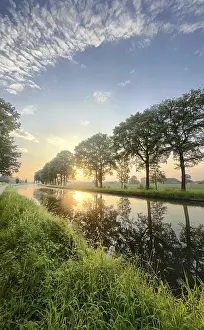 Evening Water Reflection Drucke: A tranquil river flowing gently at sunset