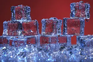 Transparent Ice Cubes Drucke: Transparent cold ice cubes on a red background