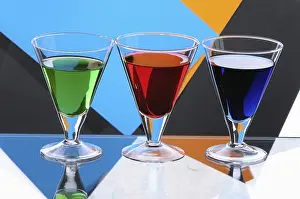Elegant Glassware Drucke: Three transparent glasses with multi-coloured drinks