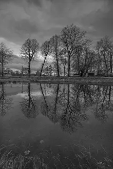 Evening Atmosphere In Central Europe Drucke: Trees reflected in a pond, evening mood