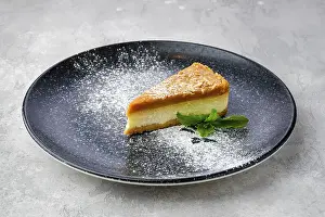 Bakery Treats Drucke: Triangular piece of caramel cheese cake on a plate