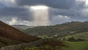 Cloudy Sky With Sun Rays Drucke: Typical landscape with stone wall
