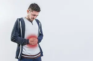 Digestive Problems Drucke: Unhappy man with digestive problems isolated