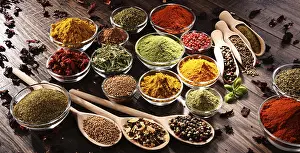 Kitchen Table Setup Drucke: Variety of spices and herbs on kitchen table