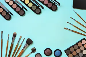 Still Life Studio Photography Drucke: Various cosmetics and brushes on blue background