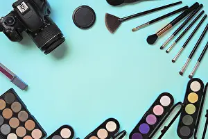 Still Life Studio Shot Drucke: Various cosmetics and brushes on blue background