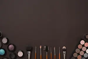 German Studio Photography Drucke: Various cosmetics and brushes on brown background