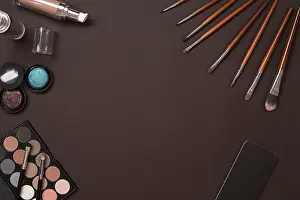 Plain Colored Background Copy Space Drucke: Various cosmetics and brushes on brown background