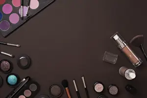 Beauty Products Drucke: Various cosmetics and brushes on brown background