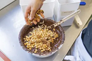 Central Europe Confectionery Drucke: Various nuts are placed in a bowl full of chocolate
