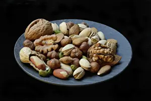 Studio Shot Of Nuts Drucke: Various nuts on plates, Germany