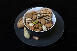 Studio Shot Of Nuts Drucke: Various nuts on plates, Germany