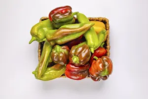 Studio Photography Of Vegetables Drucke: Various peppers (Capsicum) in baskets