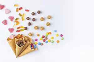 Ice Cream Cones Drucke: Various sweets in and out of ice-cream cones on a white background