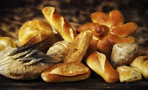 Warm Light Photography Drucke: Various types of bread in a rustic setting with warm light