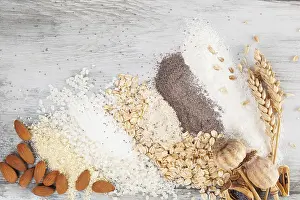Basic Food Ingredients Drucke: Various types of flours on wooden table from above