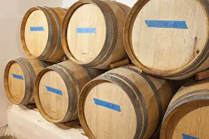 Viniculture Images Drucke: Several various wine barrels age inside cellar