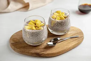 Chia Seed Superfood Benefits Drucke: Vegan chia coconut pudding with mango on white background