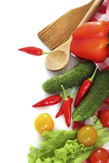 Kitchen Utensil Still Life Drucke: Vegetables still life with kitchen tools over white background