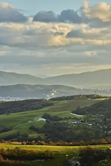 Cloudy Countryside View Drucke: Vegetation of forests and fields in the hills with clouds in evening light