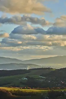 Evening Forest Scene Drucke: Vegetation of forests and fields in the hills with clouds in evening light
