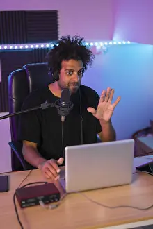 African Ethnic Male Model Drucke: Vertical photo of a content creator during a life video tutorial in studio