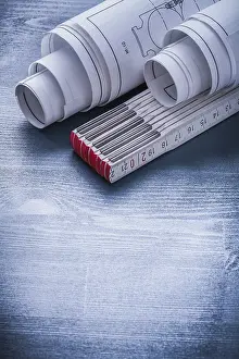 Real Estate Blueprint Drucke: Vertical version two rolls of blueprints and white wooden meter