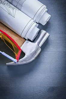 Blueprint Design Concept Drucke: Vertical view rolled up blueprints hammer goggles