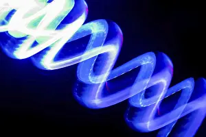 Blurred Motion Concept Image Drucke: Vibrant blue neon light trails create dynamic patterns on a dark background