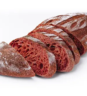 Colorful Baked Goods Drucke: Vibrant sliced loaf of beetroot bread isolated on a white background