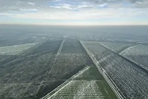 Agricultural Landscape With Snow Drucke: Top view of agricultural fields covered with snow