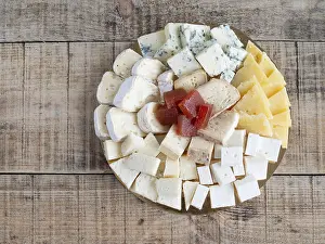 Assorted Cheese Platter Drucke: Top view assorted cheese platter with fruit paste on wooden background