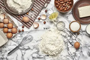 Kitchen Utensils Photography Drucke: Top view of a baking ingredients and kitchenware on a marble background