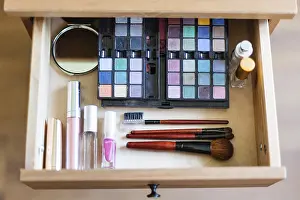 View From Above Drucke: View from above of the cosmetic set in the open drawer of the bedside table