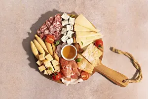 Cherry Tomato Snack Drucke: Top view of an elegant cheese platter with assorted cheeses