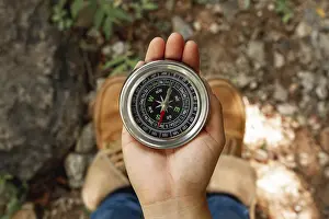View From Above Deserted Landscape Drucke: Top view female using compass directions