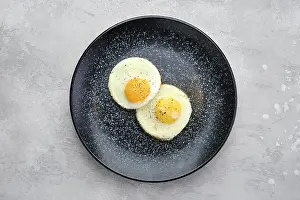 High Angle View Food Drucke: Top view of two fried eggs on a plate