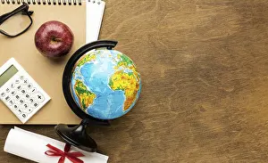 View From Above Desk Drucke: Top view globe with diploma copy space