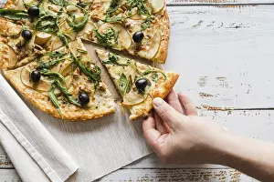 Pizza Studio Shot Drucke: Top view hand taking slice pizza