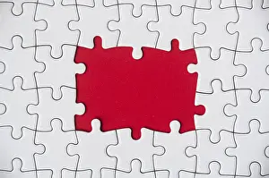 Copy Space Concept Drucke: Top view of missing jigsaw puzzle on red cover background