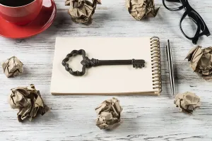 Creative Workspace Inspiration Drucke: Top view of modern creative workplace with key on notepad