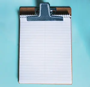 Single Colored Background Image Drucke: Top view of notepad on isolated background