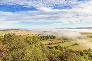 Rural Countryside Views Drucke: View of a patchwork landscape in the countryside with fog above the fields