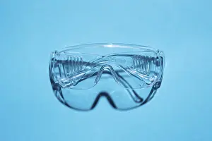 Deserted Blue Background Image Drucke: Top view of plastic goggles against a blue background