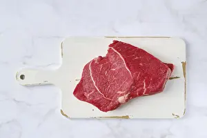 Beef Steak Drucke: Top view of raw top side beef steak on marble background